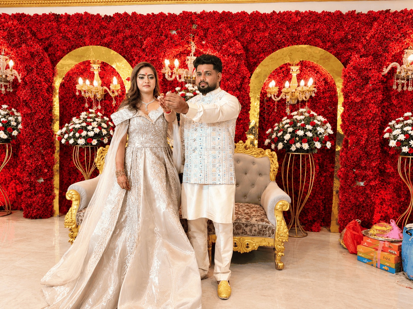 The couple dancing mid-twirl under string lights at the sangeet